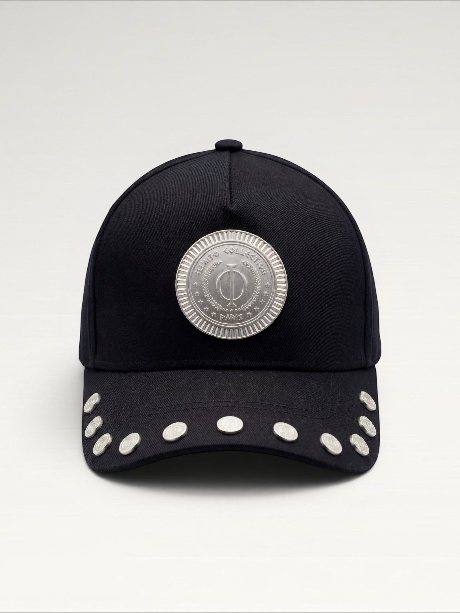ILIMITO black cotton blend cap with curved brim, silver medallion detail on front, and silver medal accents on visor.