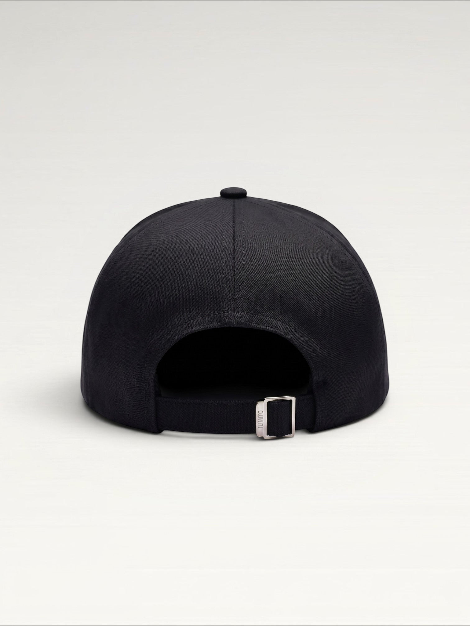 ILIMITO black cotton blend cap with curved brim, silver medallion detail on front, and silver medal accents on visor.