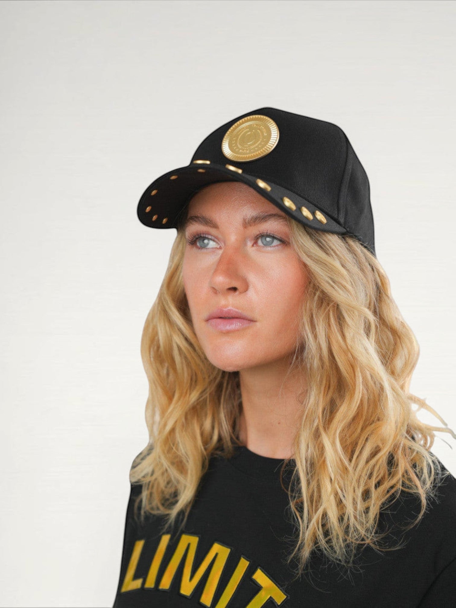 ILIMITO black cotton blend baseball cap with gold medallion emblem and gold medal accents on the visor.
