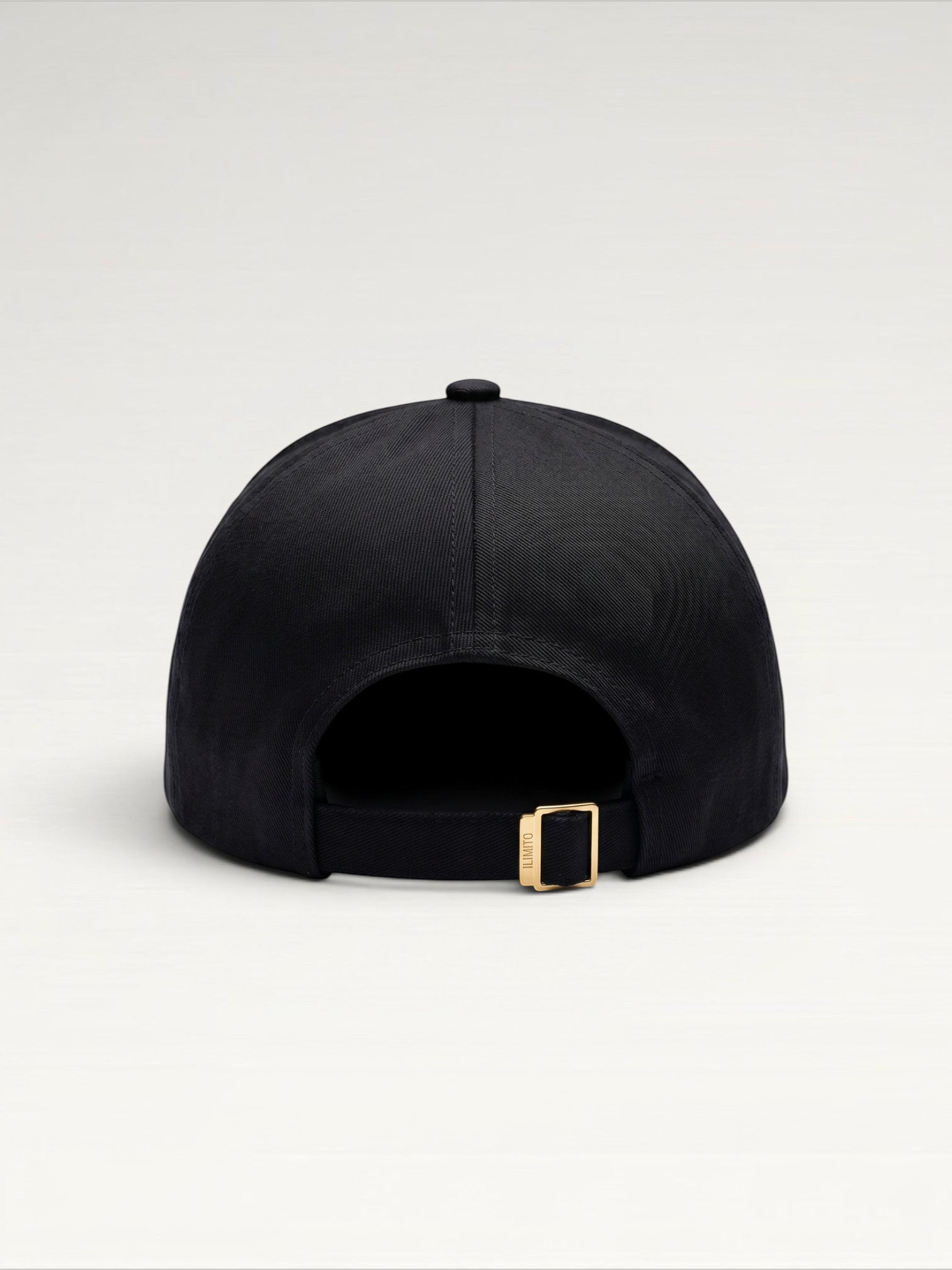 ILIMITO black cotton blend baseball cap with gold medallion emblem and gold medal accents on the visor.