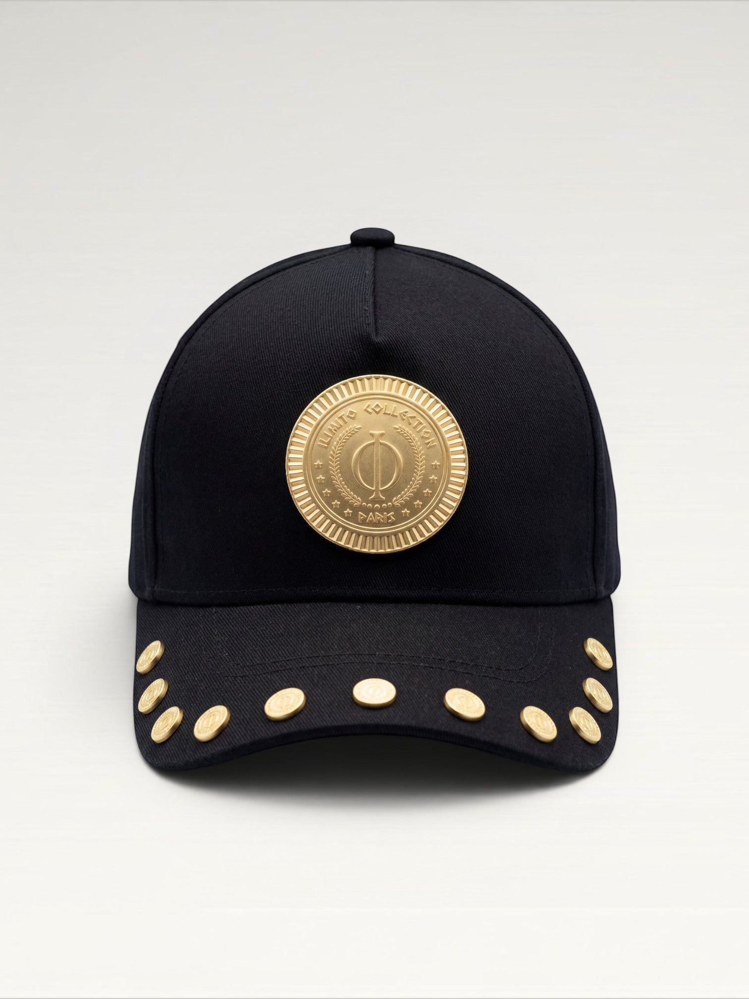 ILIMITO black cotton blend baseball cap with gold medallion emblem and gold medal accents on the visor.