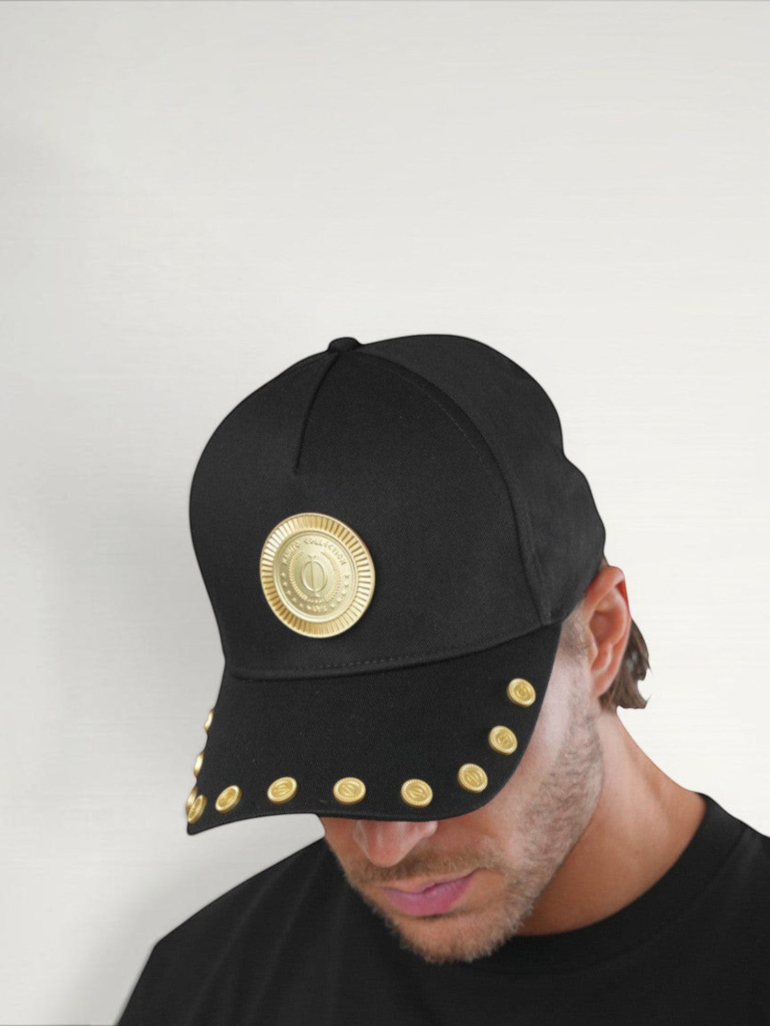 ILIMITO black cotton blend baseball cap with gold medallion emblem and gold medal accents on the visor.