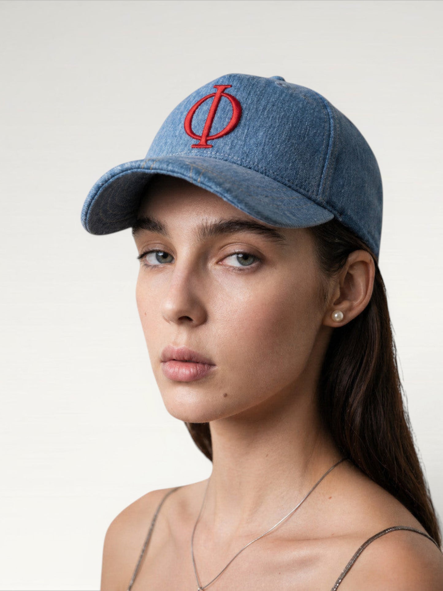 ILIMITO light wash denim baseball cap with red embroidered logo emblem, curved brim, adjustable strap. Unisex fit.