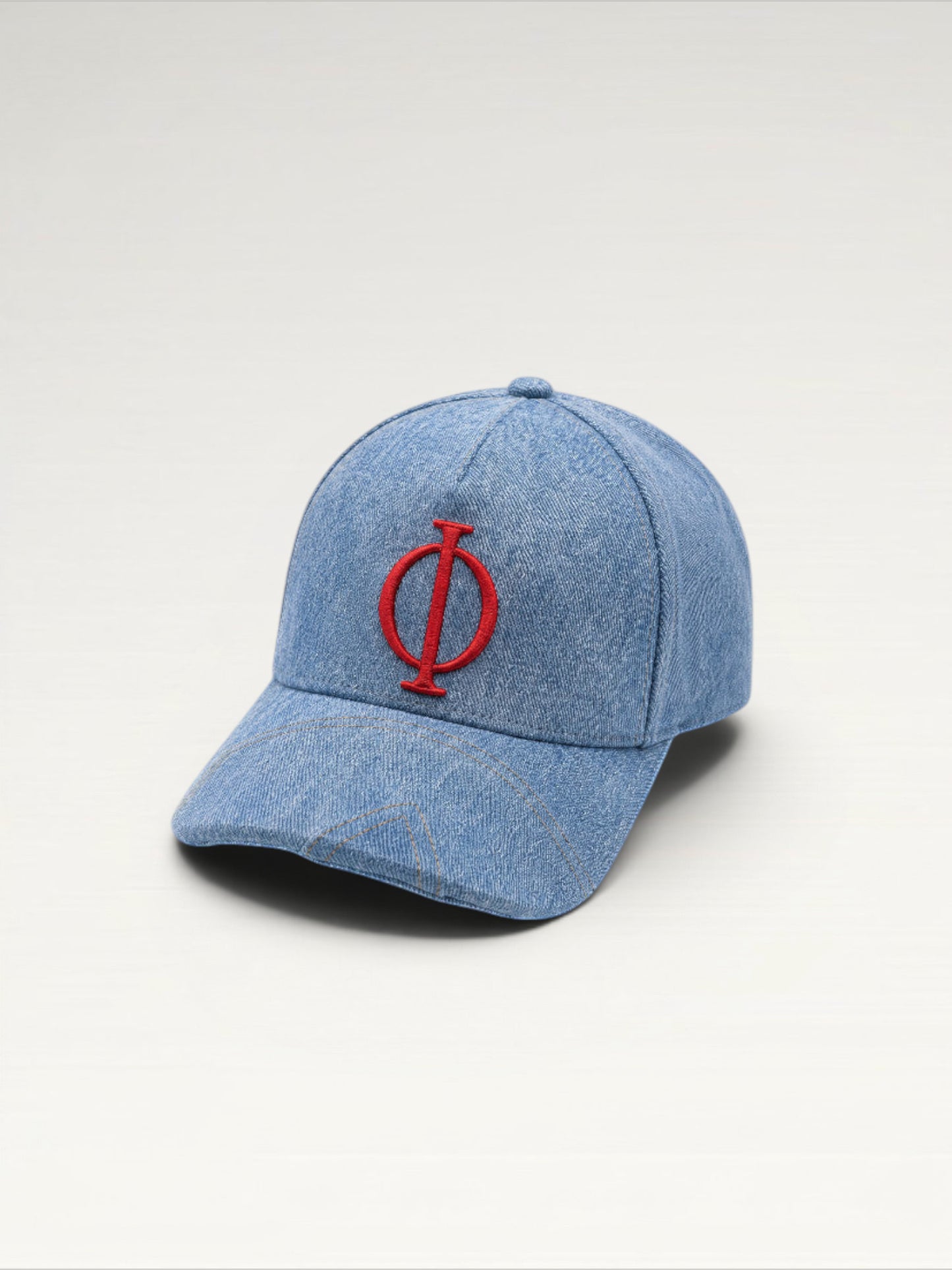 ILIMITO light wash denim baseball cap with red embroidered logo emblem, curved brim, adjustable strap. Unisex fit.