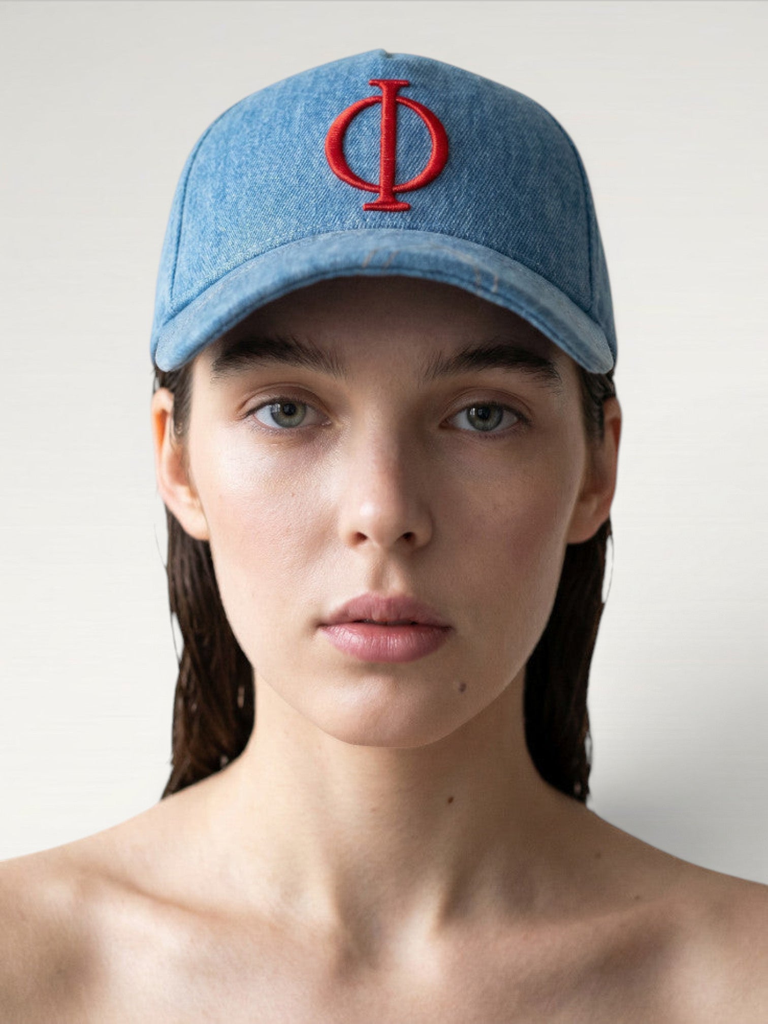 ILIMITO light wash denim baseball cap with red embroidered logo emblem, curved brim, adjustable strap. Unisex fit.