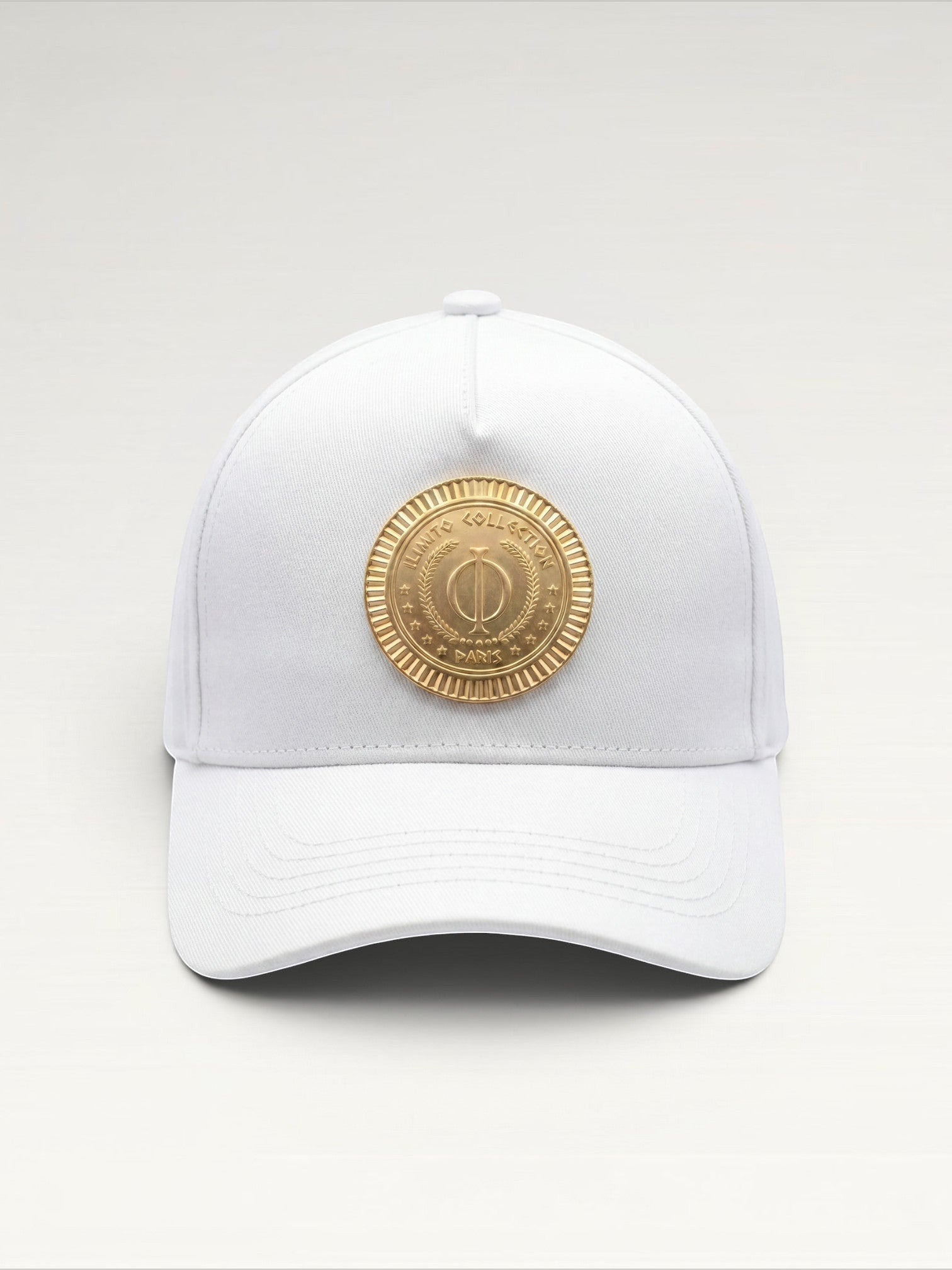 ILIMITO white cotton blend baseball cap with curved brim and gold medallion emblem. Unisex fit.