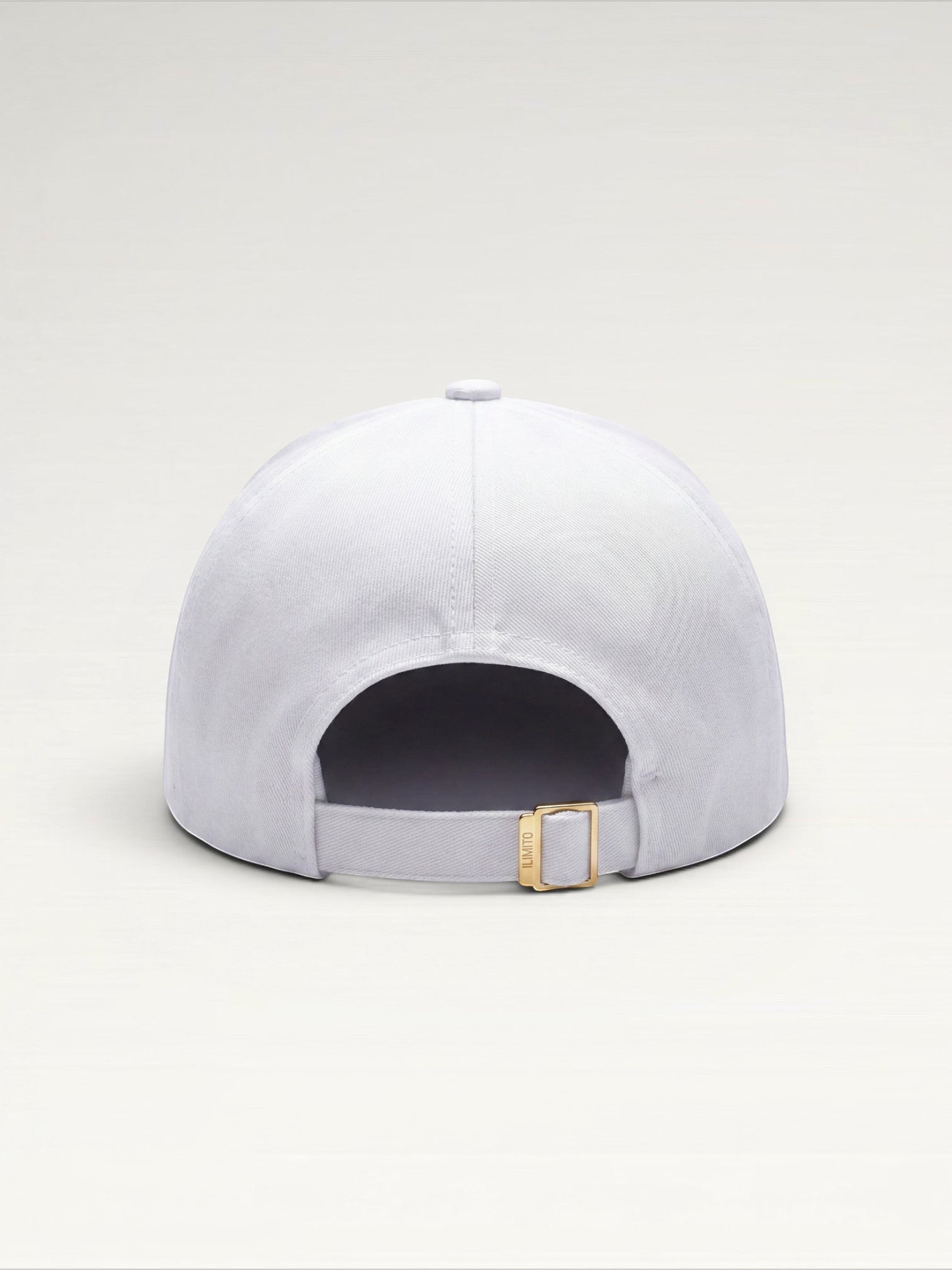 ILIMITO white cotton blend baseball cap with gold medallion detail and adjustable strap