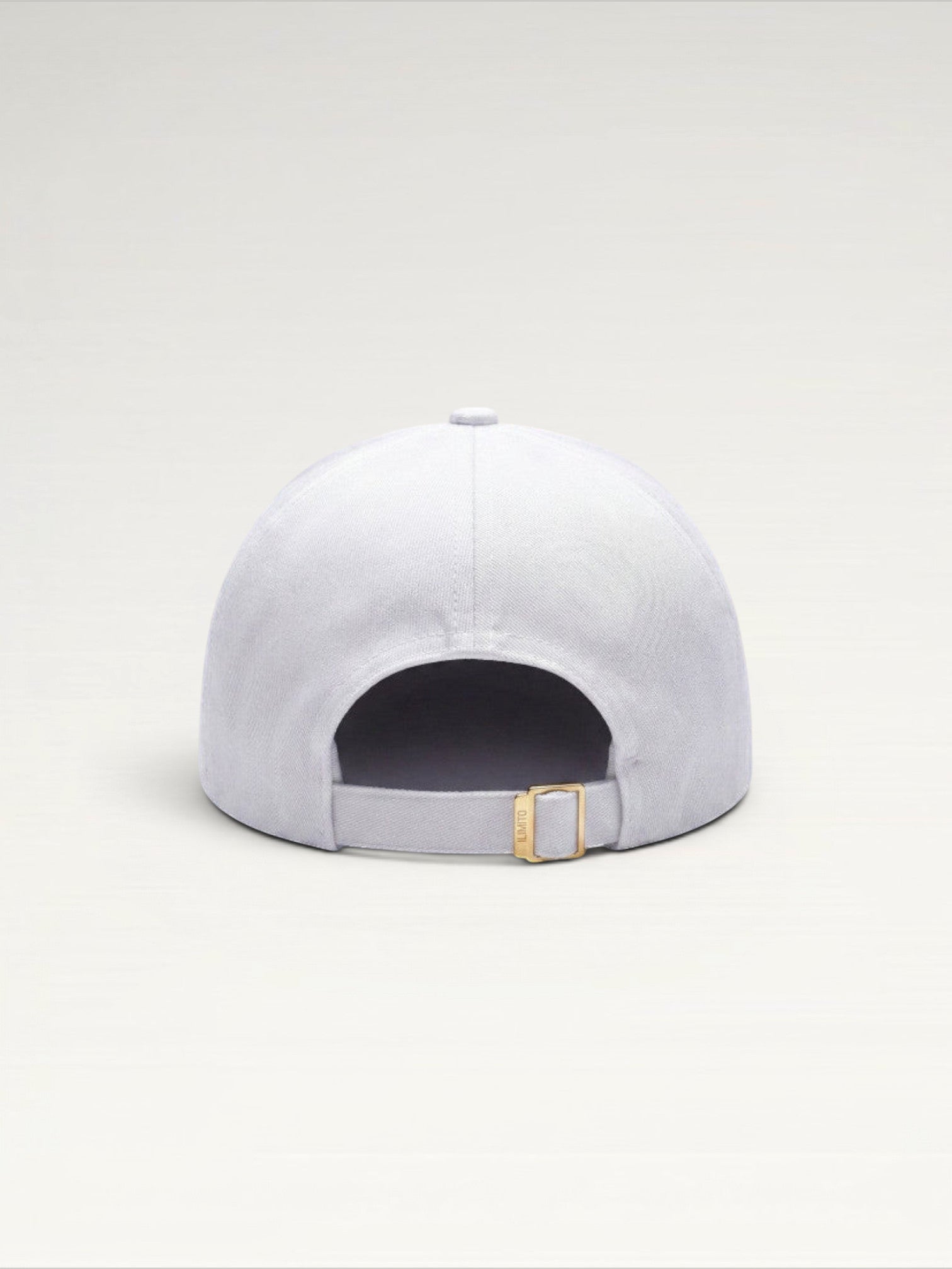 ILIMITO white cotton blend cap with gold medallion detail and accents on the visor. Unisex, adjustable fit