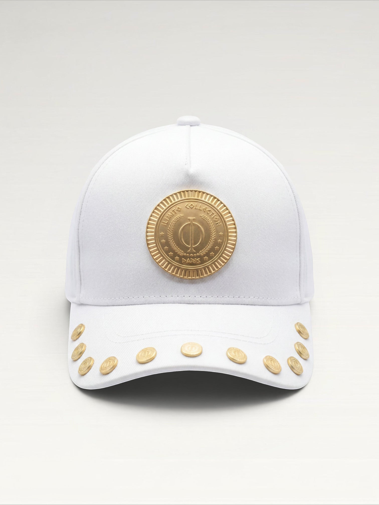 ILIMITO white cotton blend baseball cap with gold medallion emblem and gold medal accents on the visor.