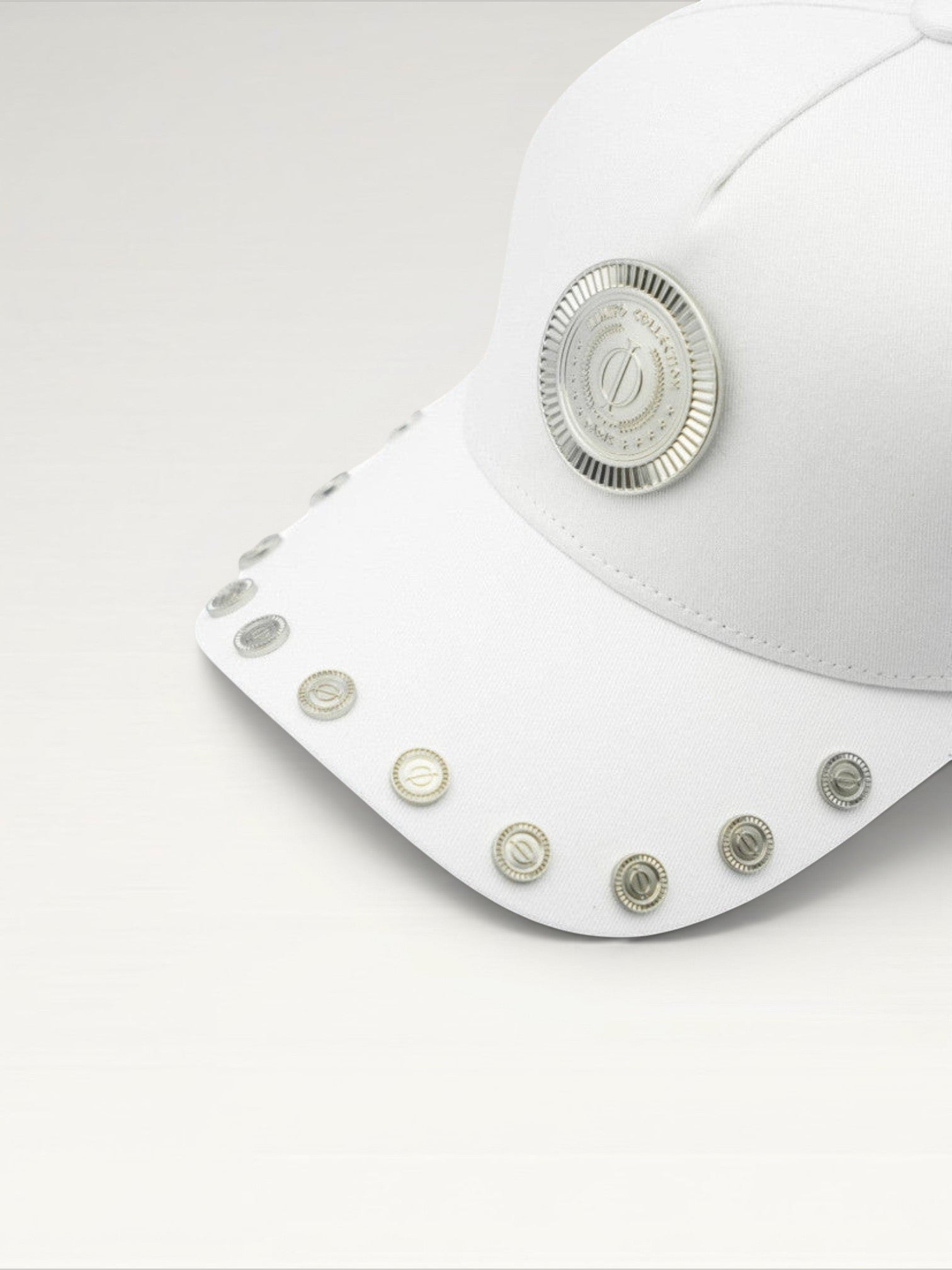 ILIMITO white cotton blend cap with silver medallion detail and accents on the visor. Unisex, adjustable fit.