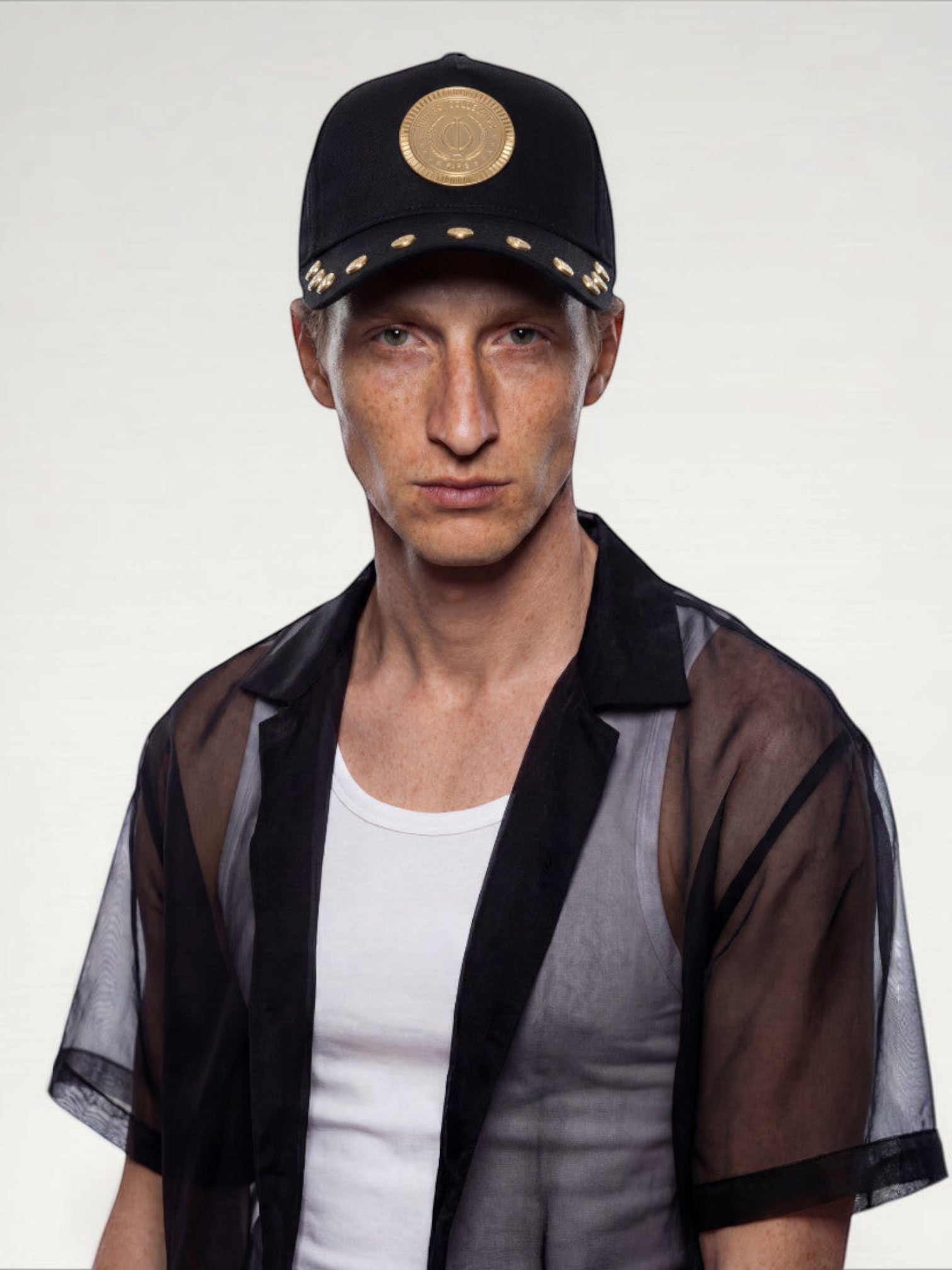 ILIMITO black cotton blend baseball cap with gold medallion emblem and gold accents on the visor. Unisex fit.