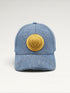 ILIMITO light blue denim baseball cap with curved brim and a central gold medallion emblem. Unisex fit.