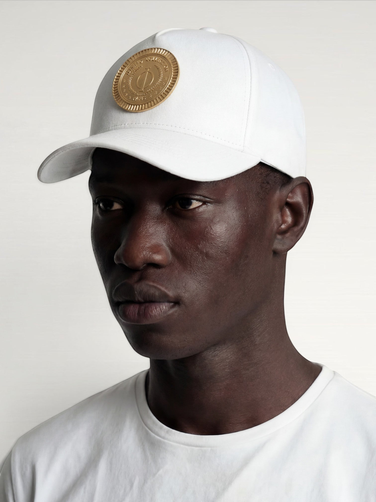 ILIMITO white cotton blend baseball cap with curved brim and gold medallion emblem, unisex fit