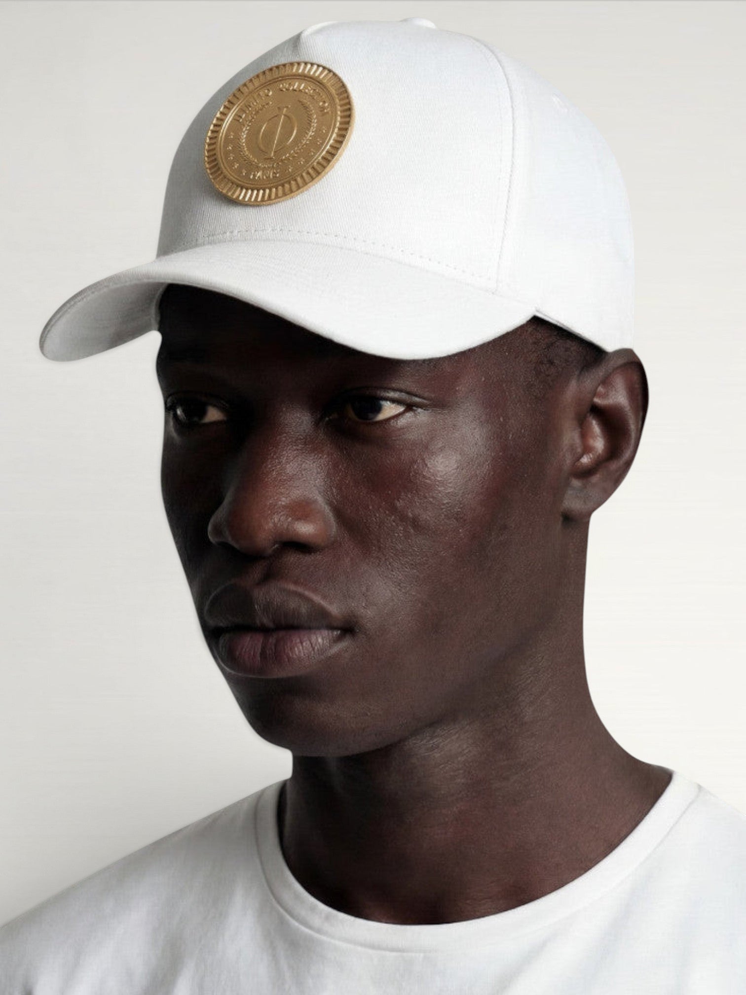 ILIMITO white cotton blend baseball cap with curved brim and gold medallion emblem, unisex fit